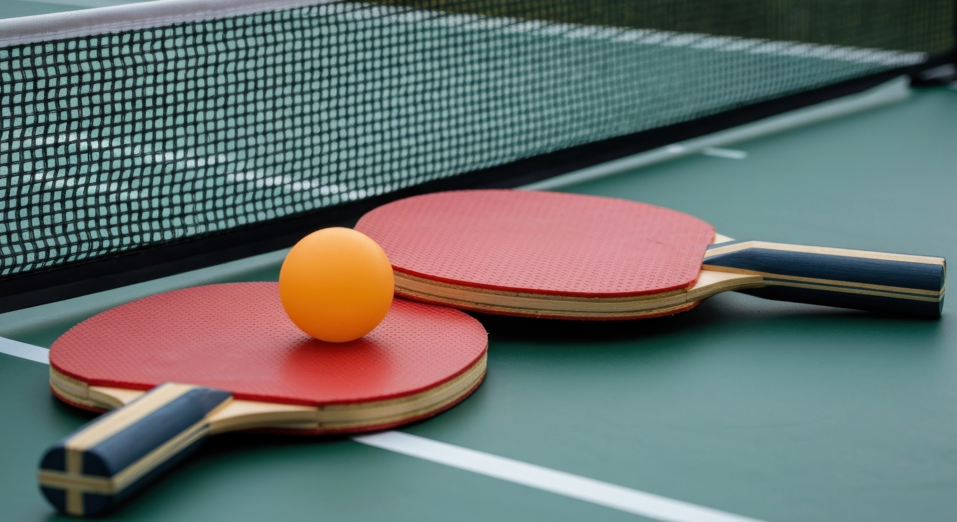 Ping pong paddle and ball on a table